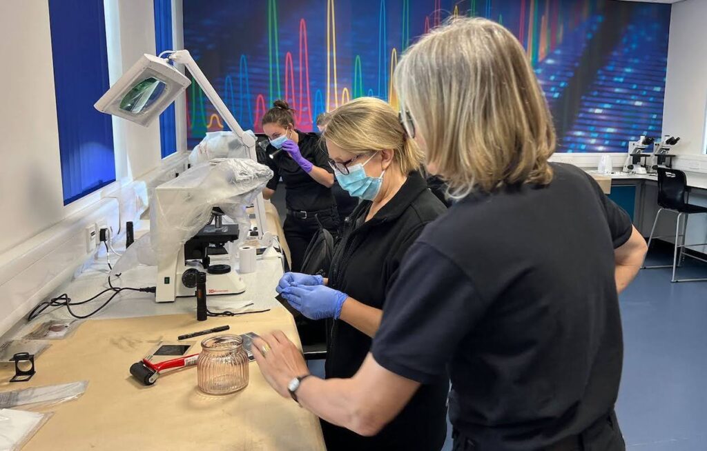 CSI practising their fingerprinting techniques using powders and brushes
