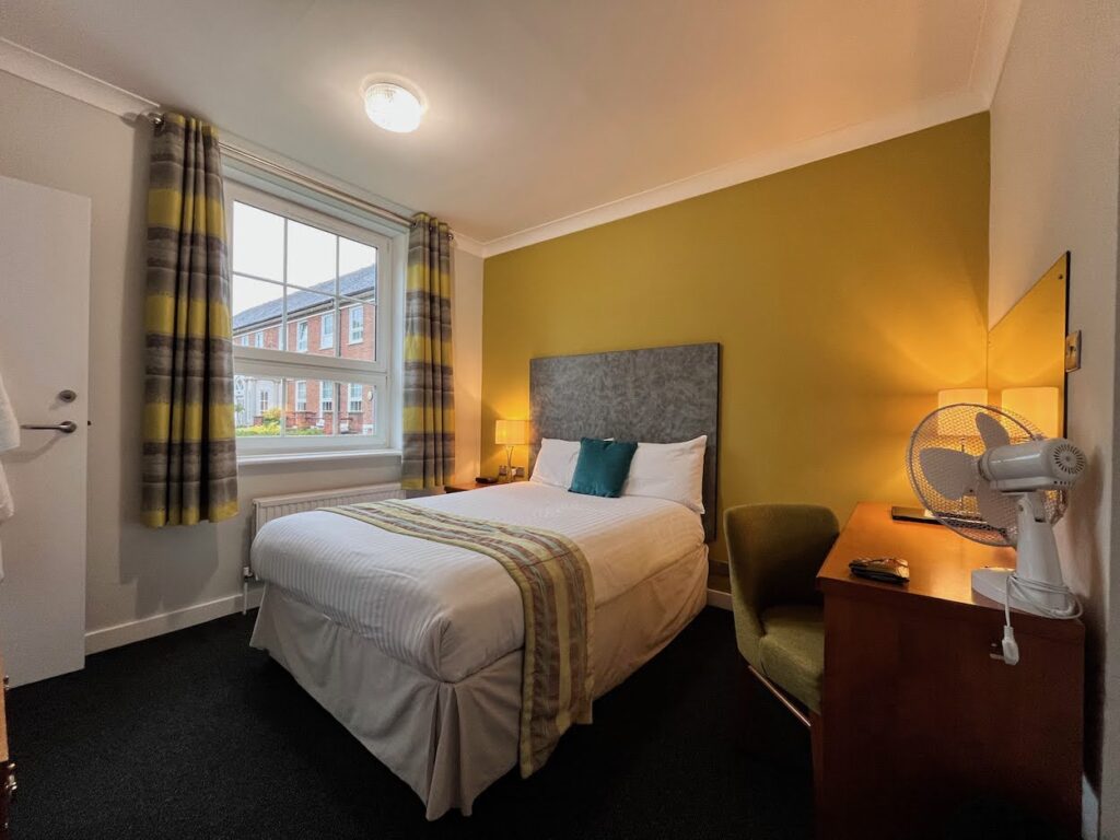 A small double bed in one of the bedrooms of Mitchell Hall, hotel at Cranfield University.