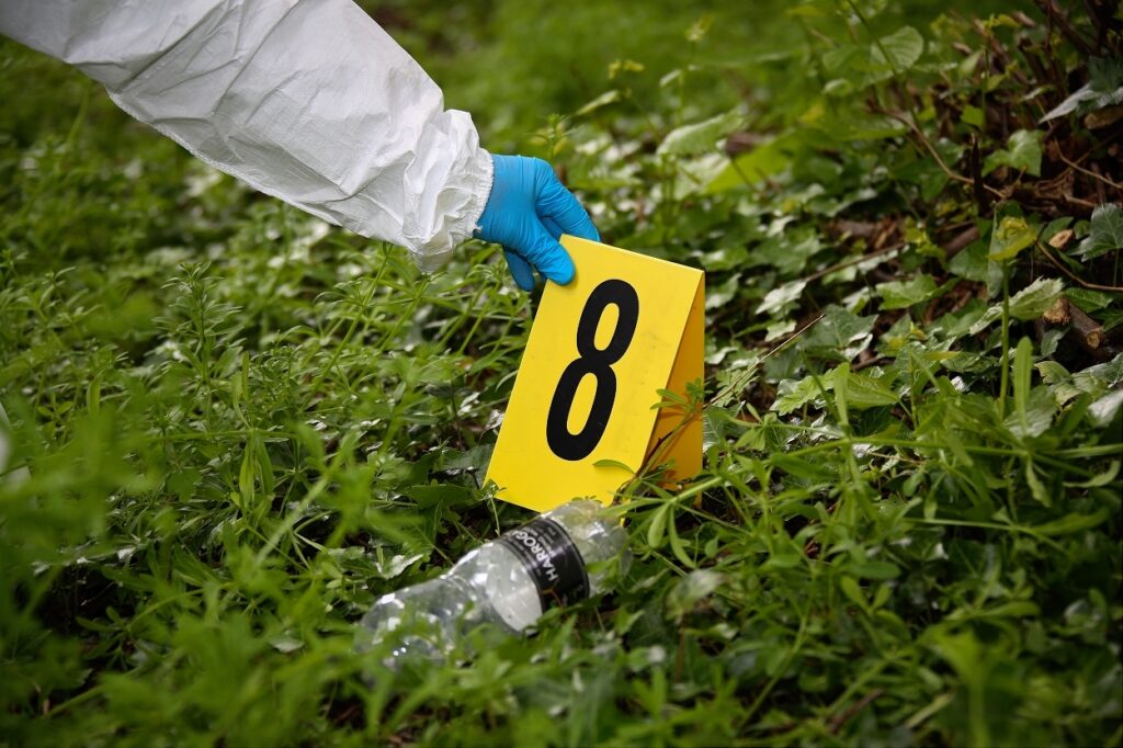 A scene marker is being placed adjacent to potential forensic exhibit