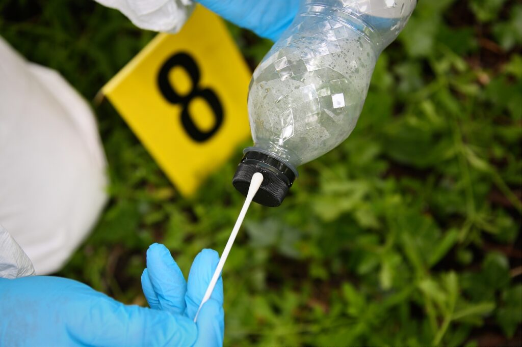 A plastic bottle being swabbed for DNA
